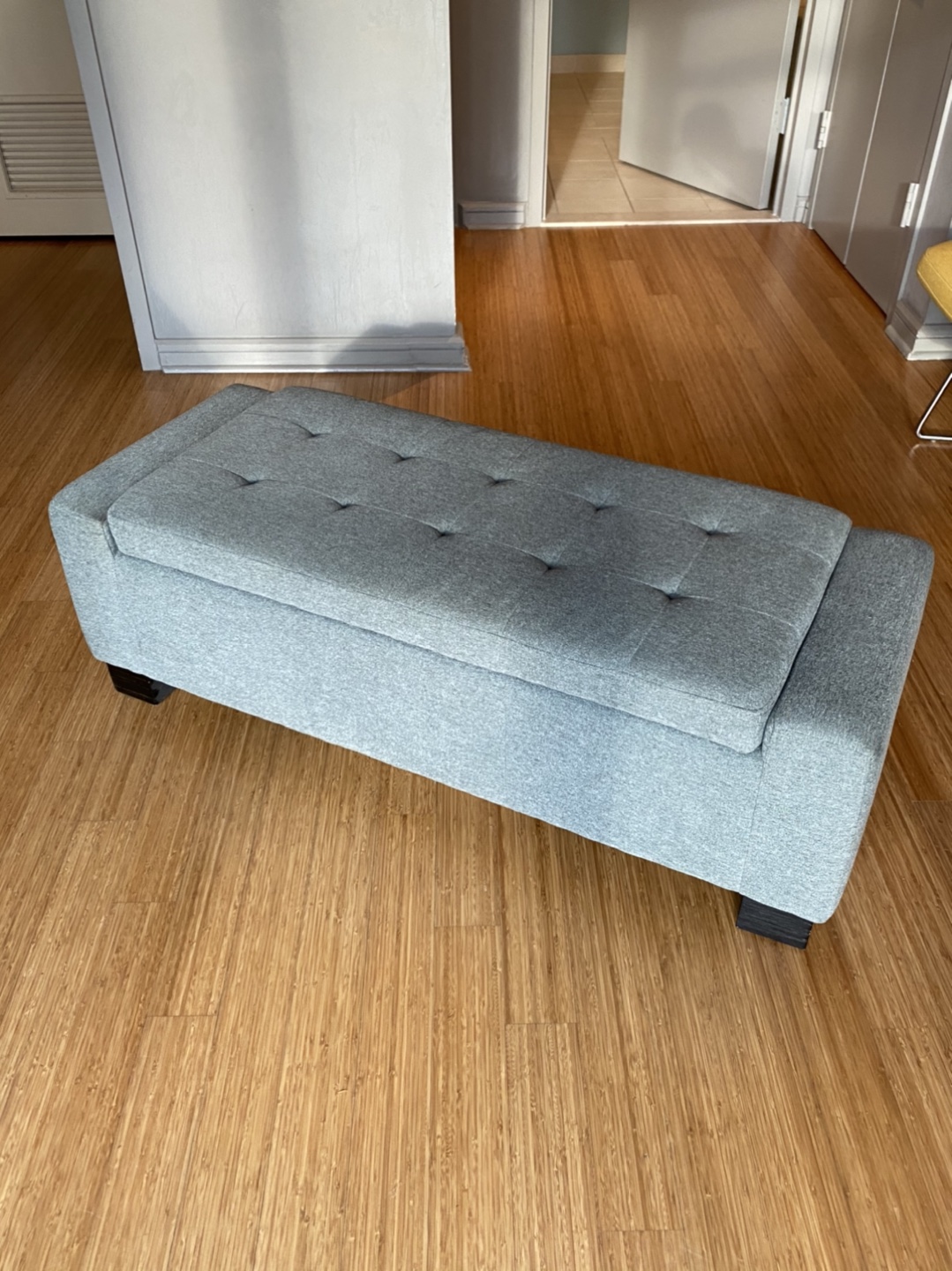 Light Grey fabric upholstered storage bench.