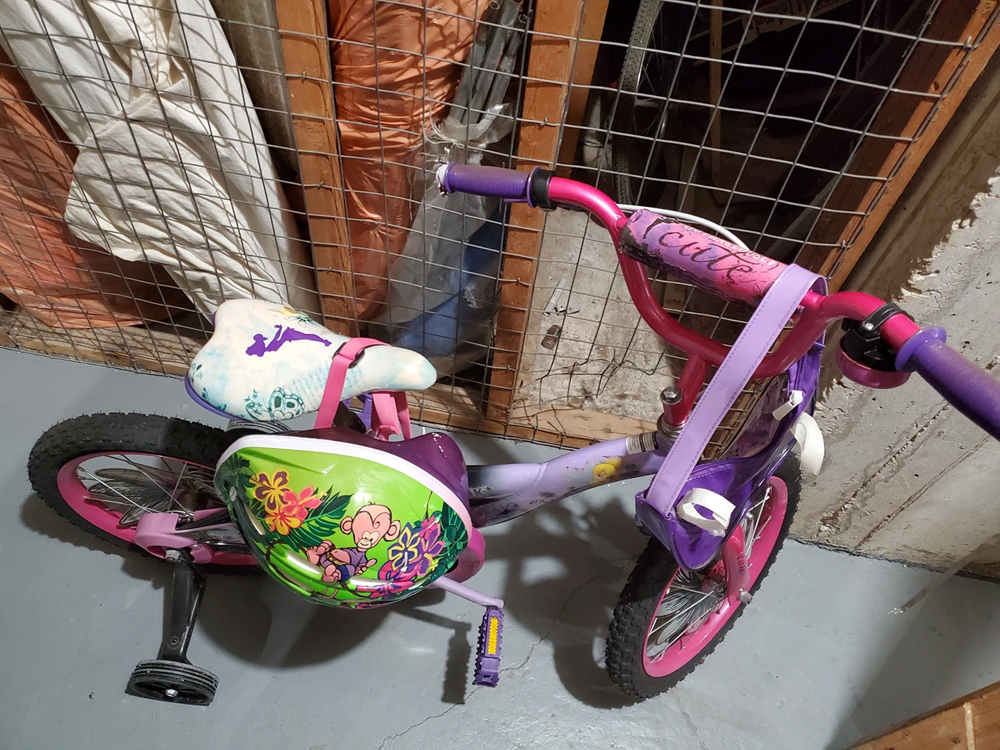 Girl's bicycle with training wheels and helmet