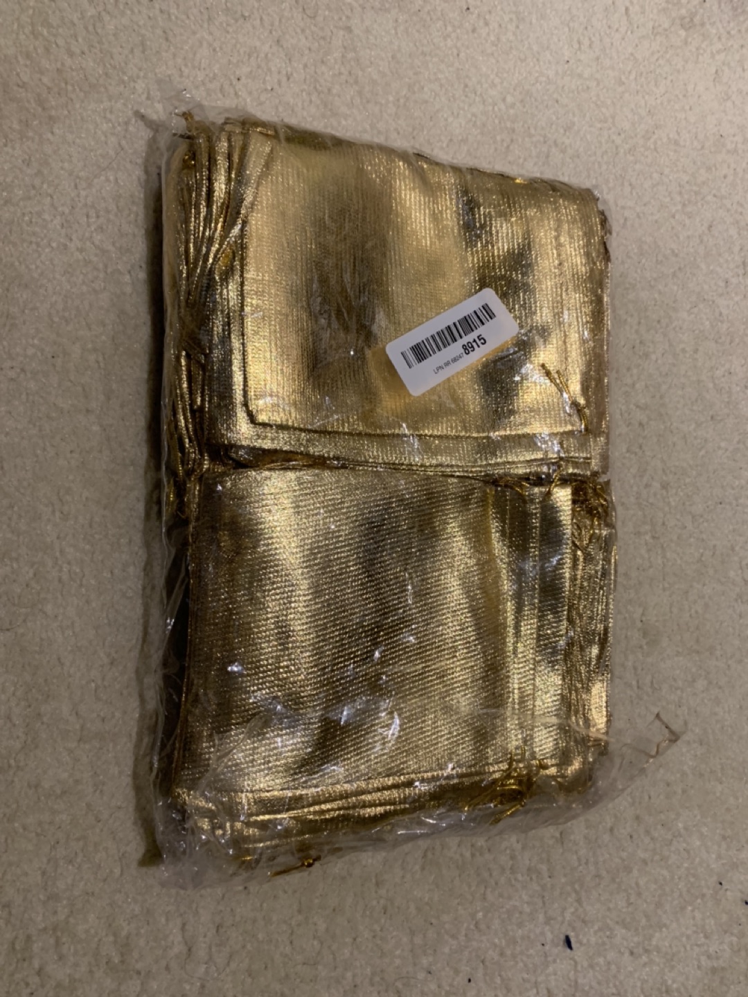 Nearly 100 small golden gift bags