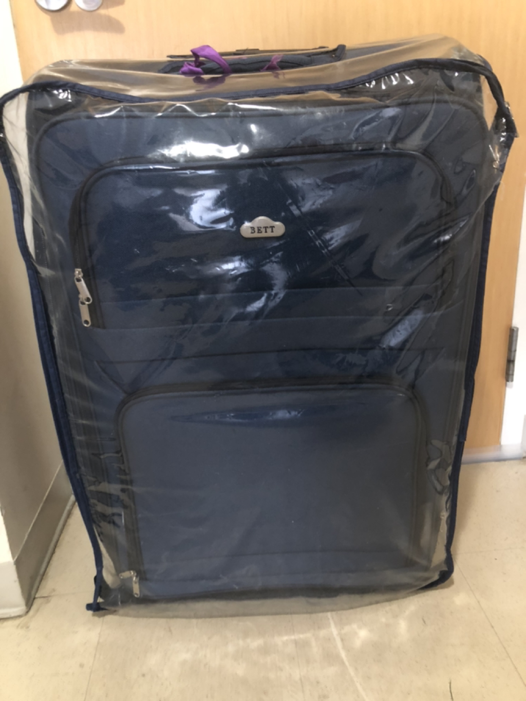 Large suitcase with rain cover