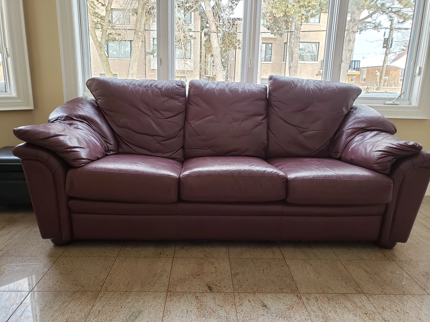 Gently used leather couch, wine colour