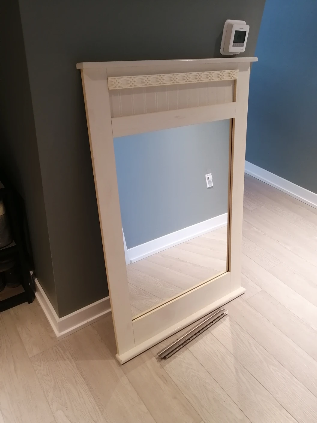 white mirror with wooden details