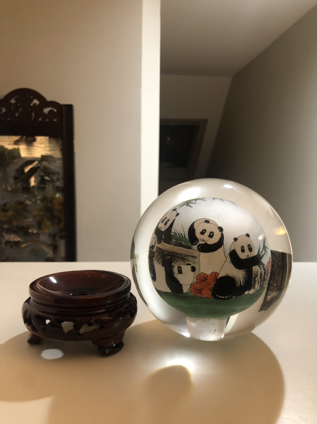 Glass globe with pandas drawn inside. image indicator(3)
