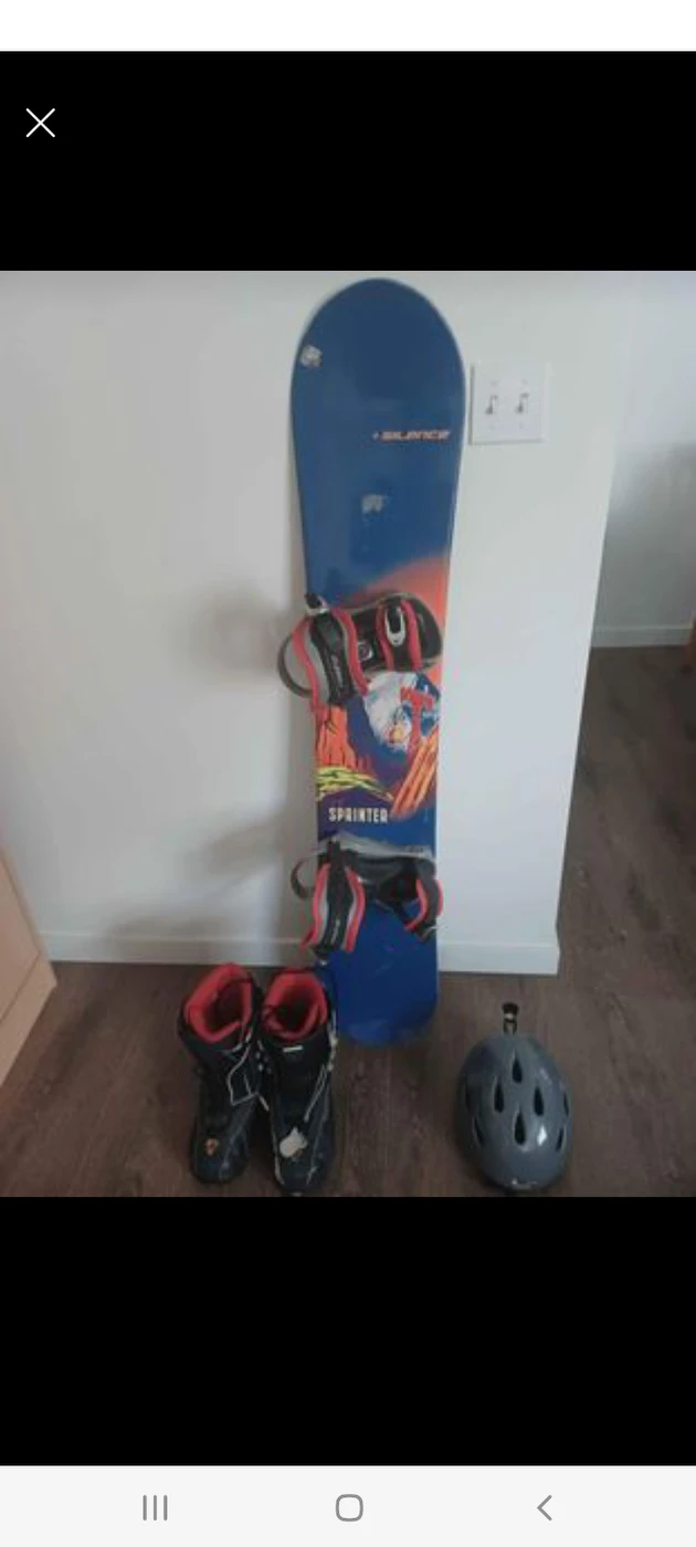 Snowboard with booths and helmet