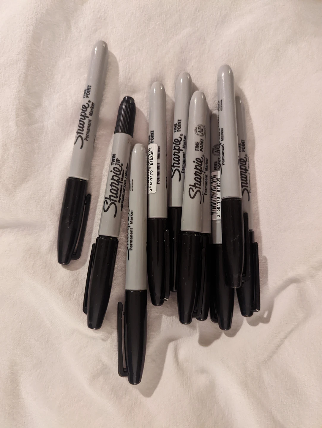 black Sharpies, pens and pencils