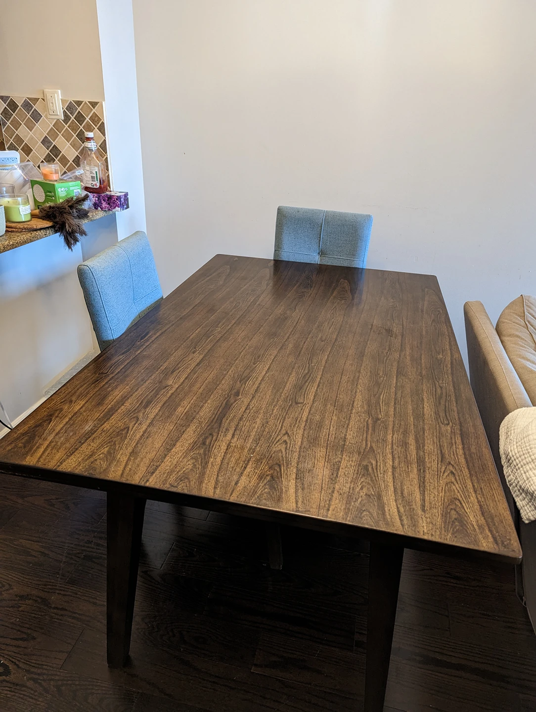 Wood dining table with four blue  fabric chairs