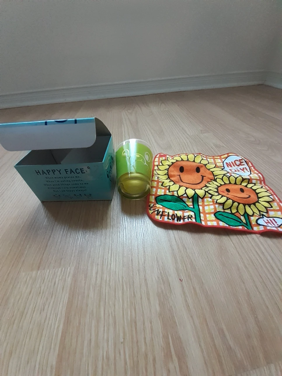 Brand new happy face drinking glass with towel