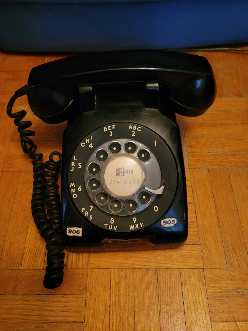 Rotary telephone with volume control