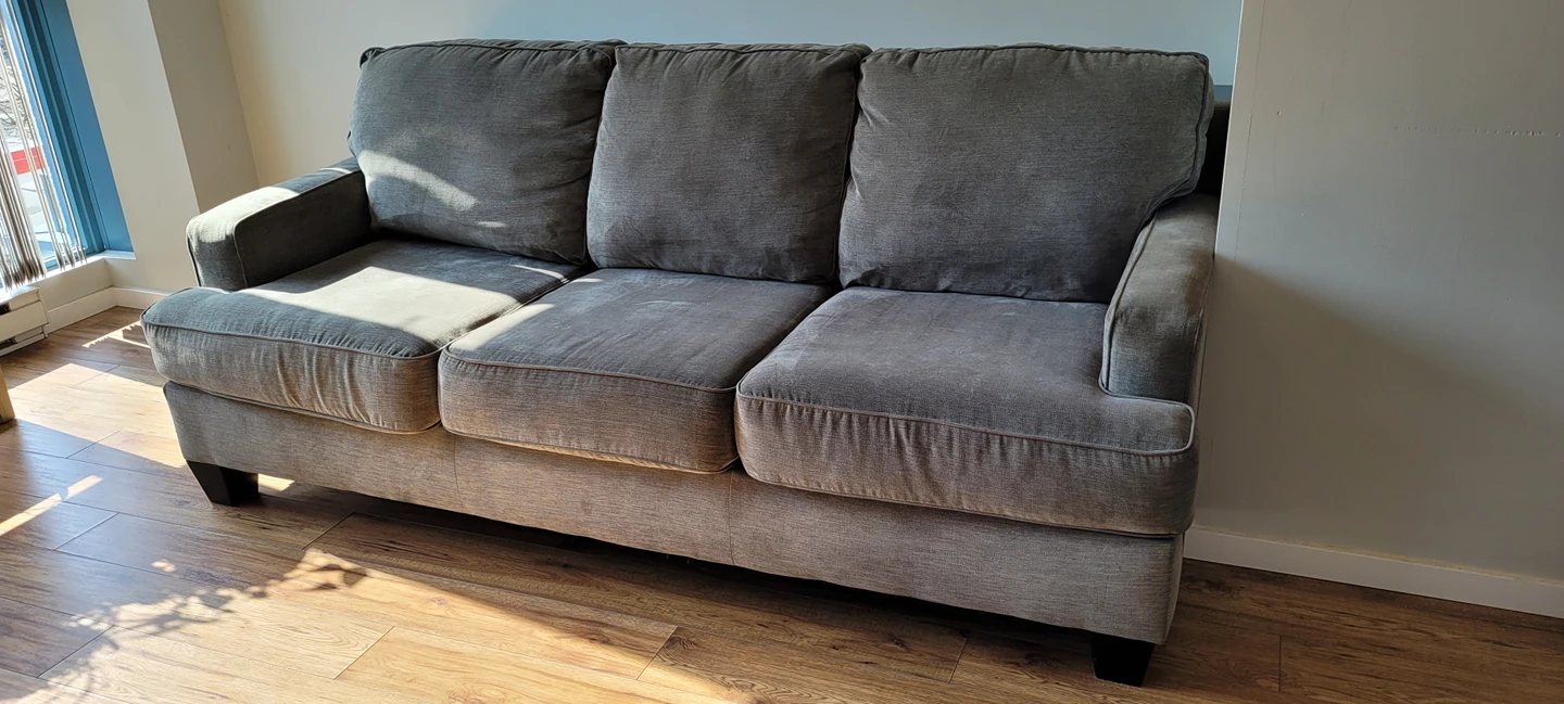 Grey suede couch with console table