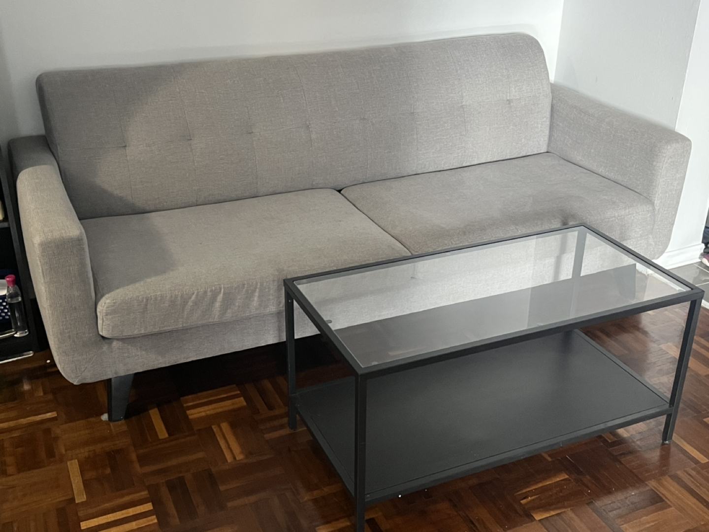 Grey couch with black coffee table