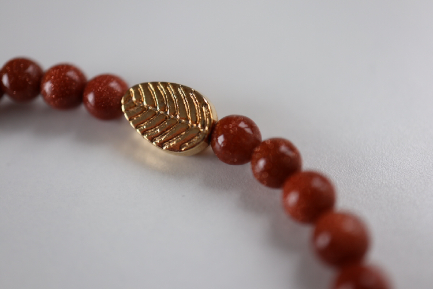 Delicate bracelet with golden figures