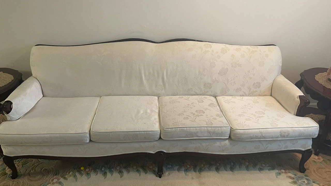 sofa set with end tables and coffee table and brown carpet
