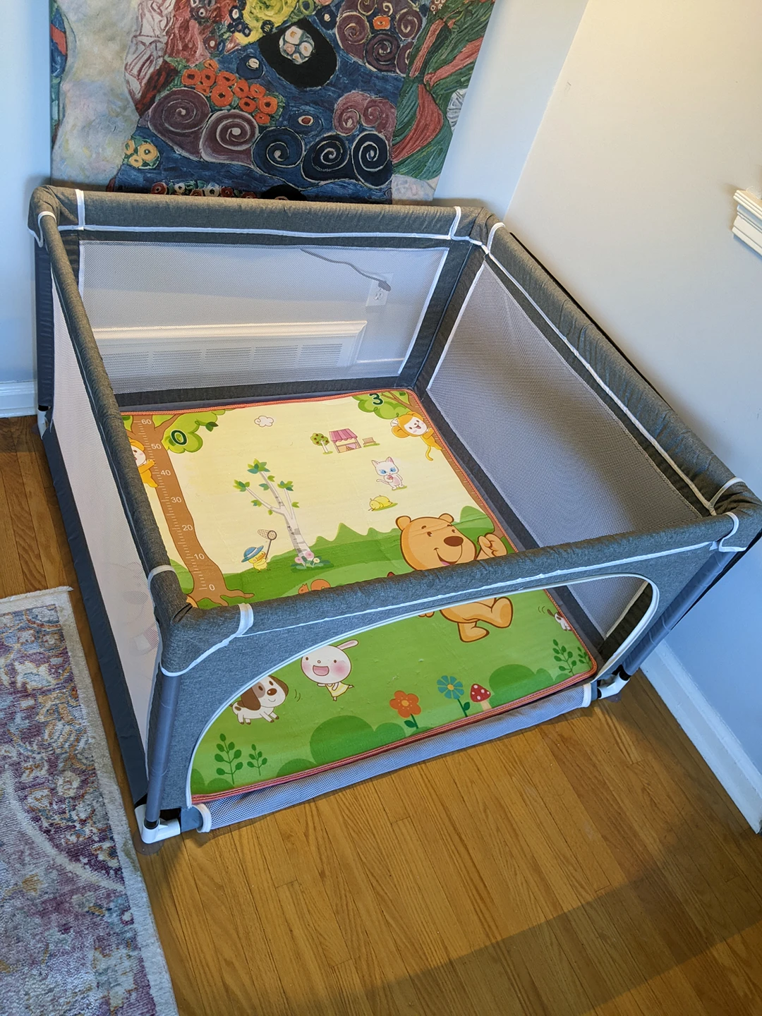 Playpen with reversible crawling mat and zip up door