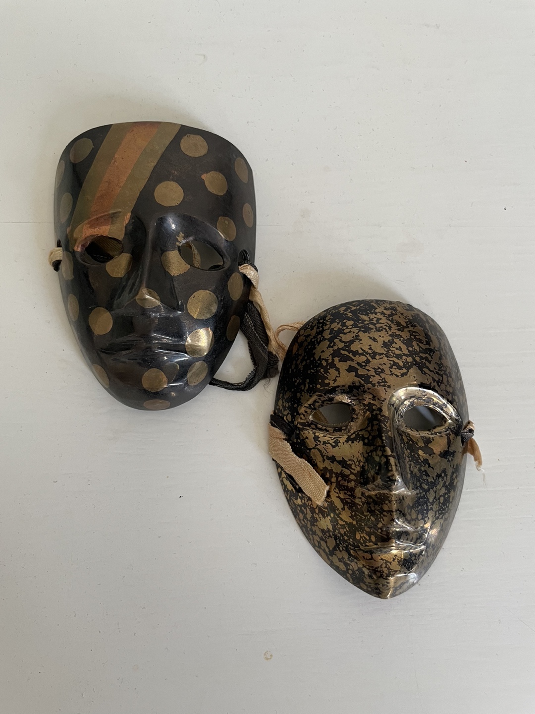 Two Antique Metal Black and Gold Masks thumbnail
