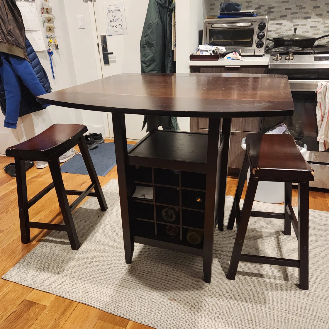 Dining table with 2 stools and wine rack