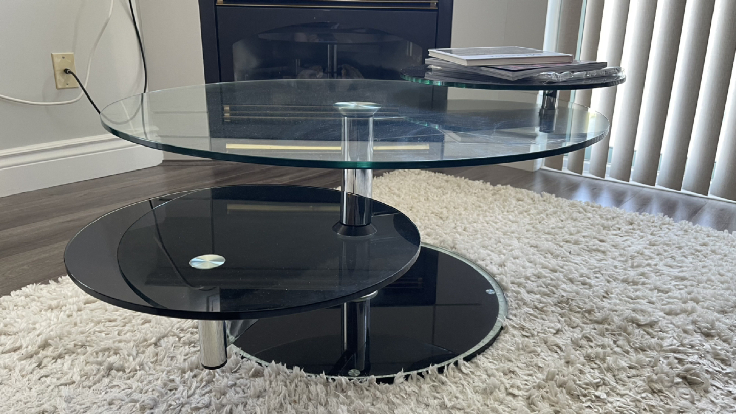 $50 glass modern coffee table with 360 degree rotating arms