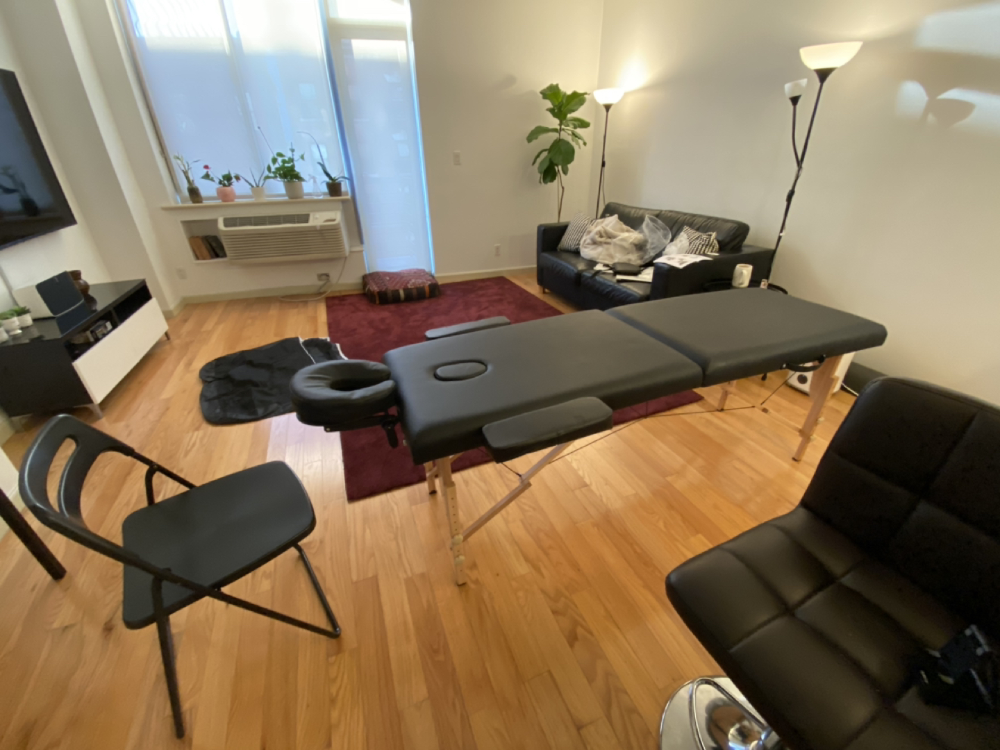 Massage table, rolling stool, mannequin head.