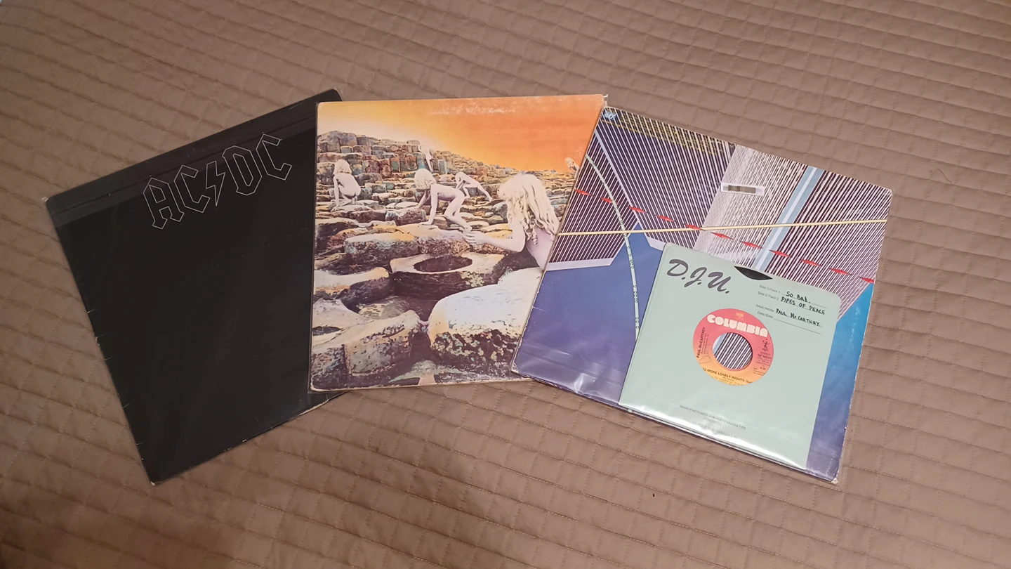 Three vinyl records and two 45s thumbnail