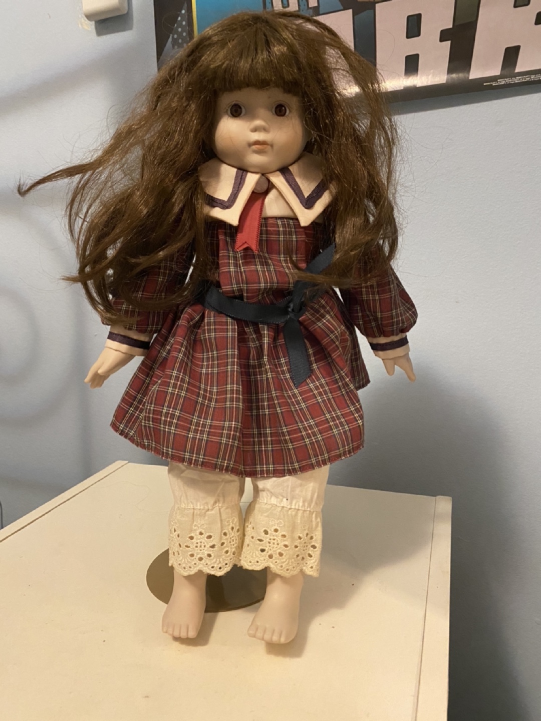 Vintage porcelain doll on stand