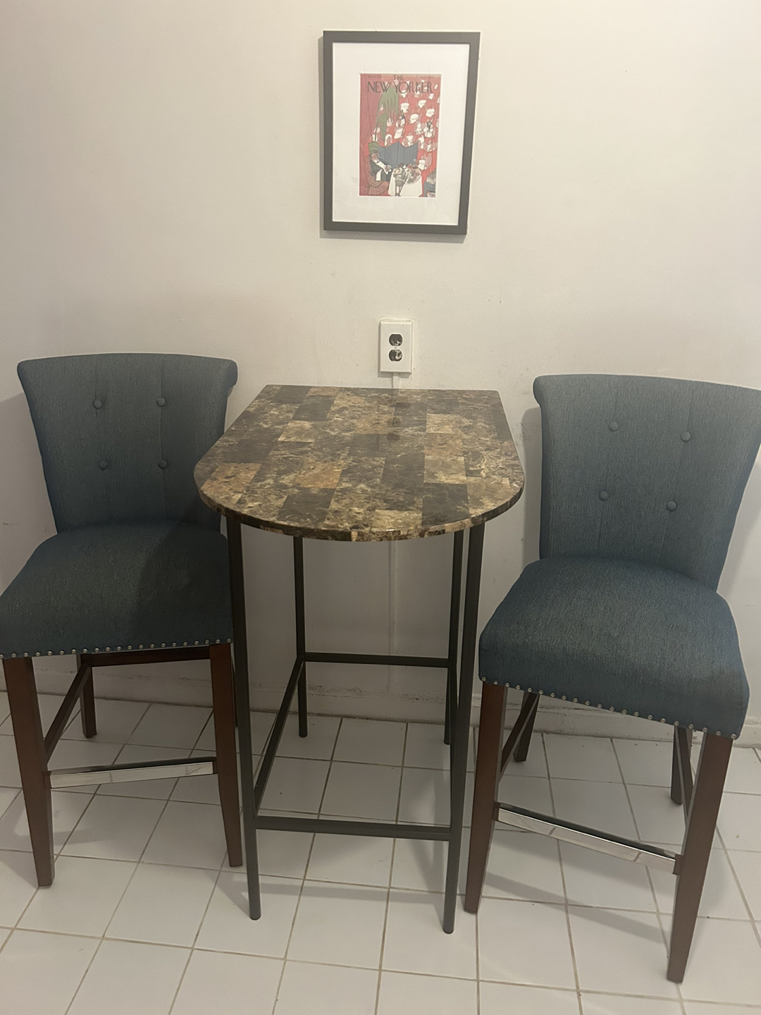 Two bar stool chairs and table