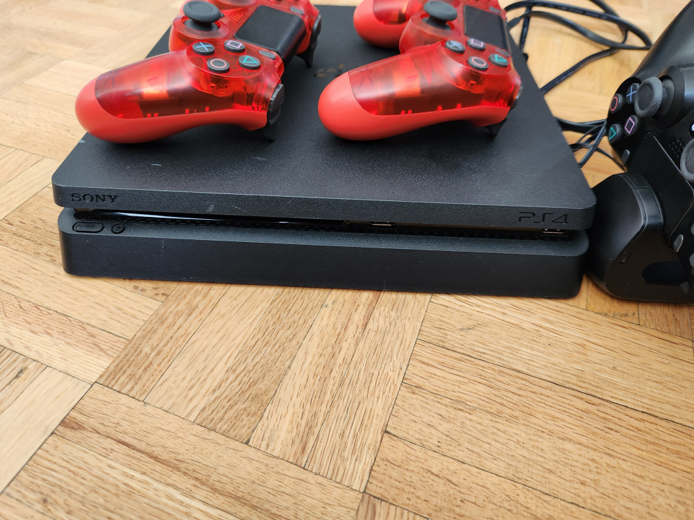 PS4 with 4 controllers and charging stand. - photo 2