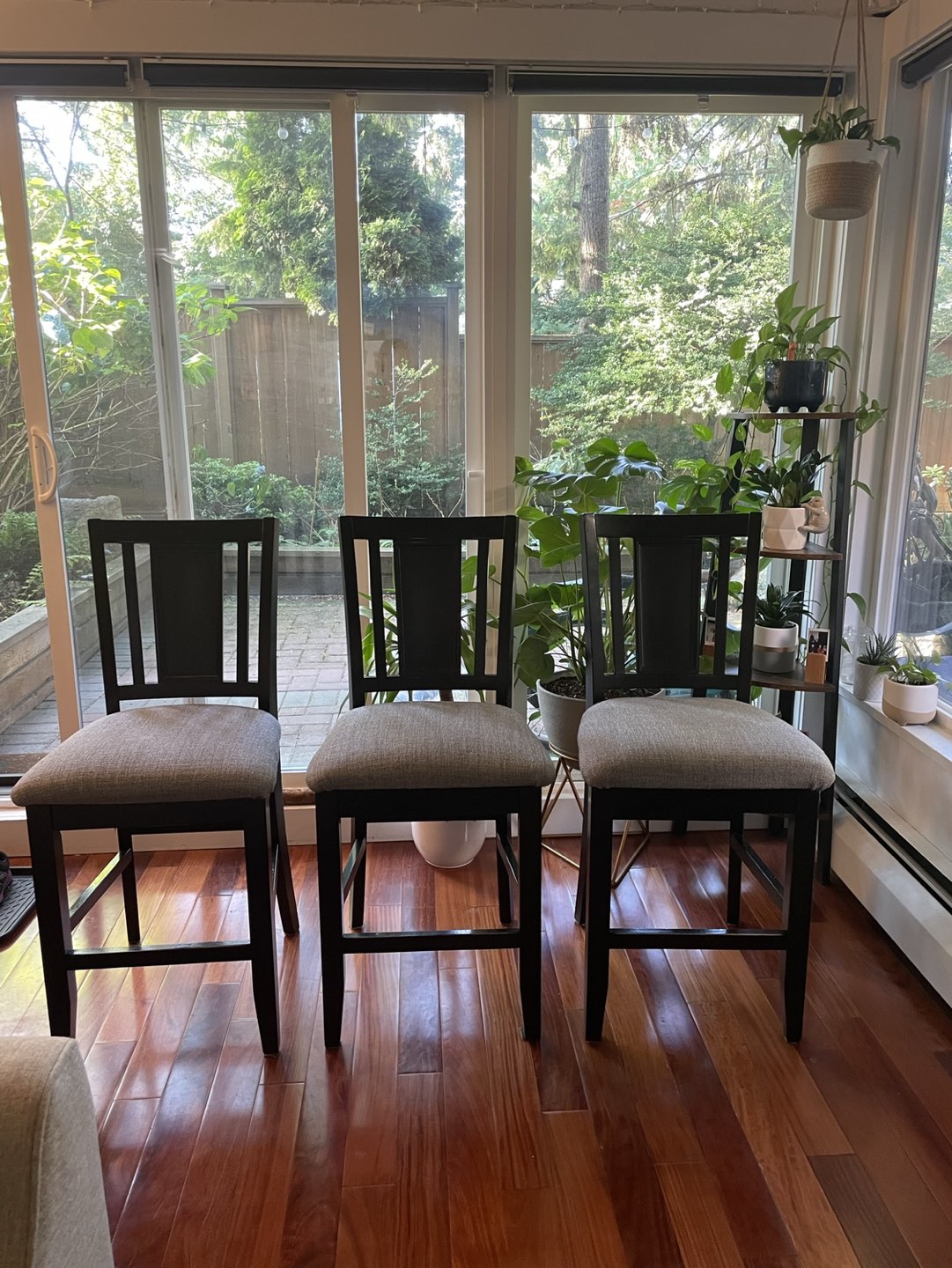 Three wood framed upholstered counter stools