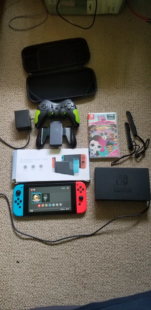 nintendo switch with dock, extra controller, and one video game. thumbnail