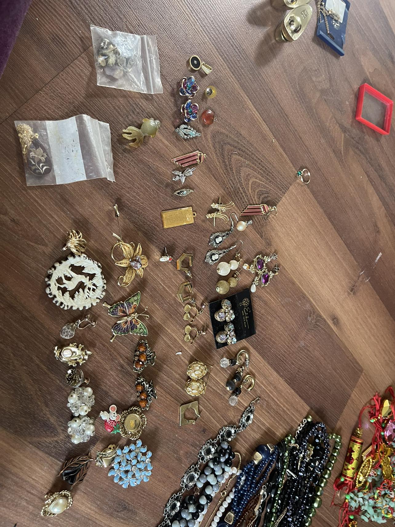 assorted earrings, pins, decorative pieces,etc.