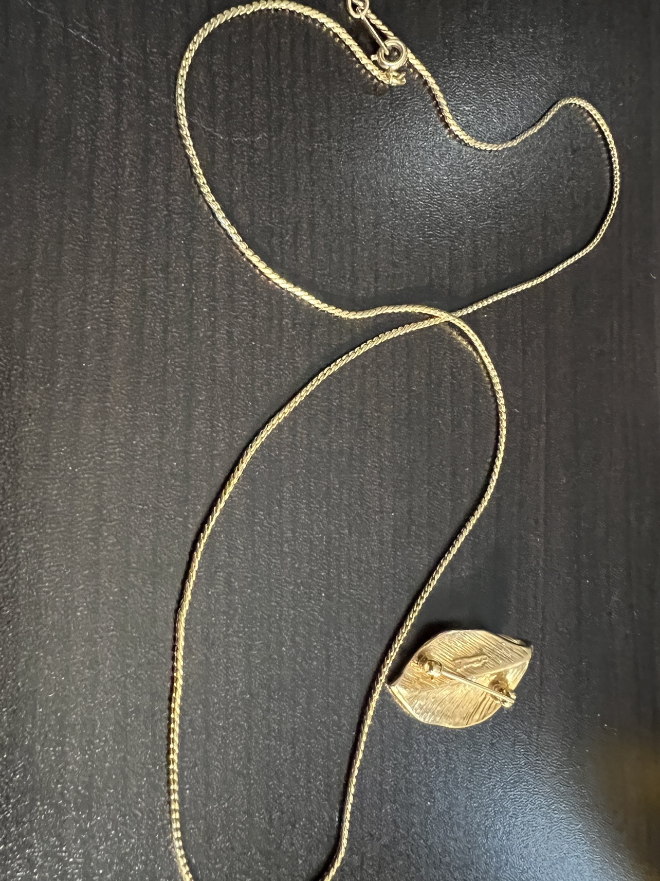 gold tone necklace leaf pendant that is also a brooch.