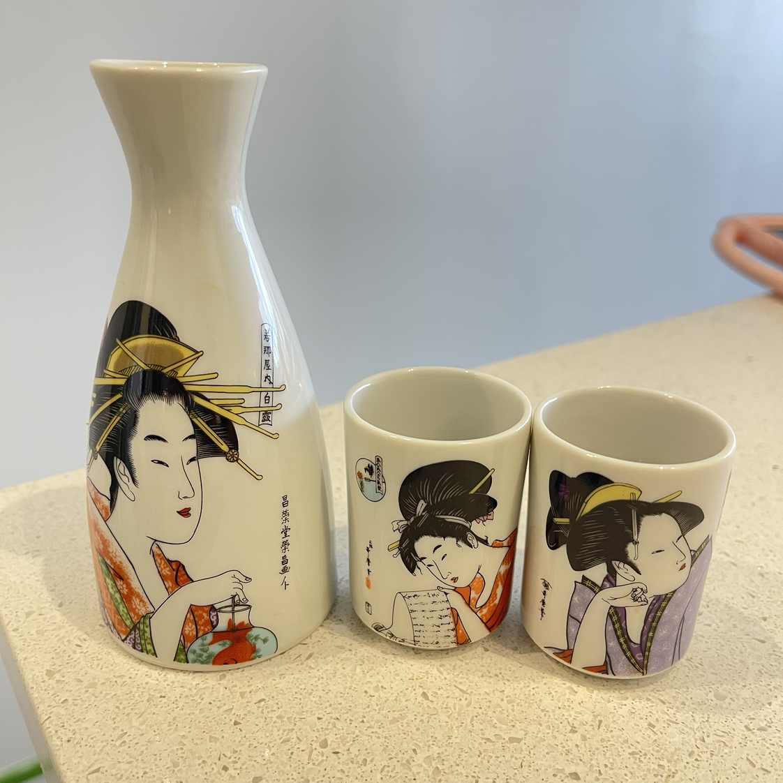 Sake serving bottle and two cups thumbnail
