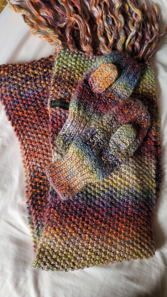 Knitted scarf with a pair of gloves