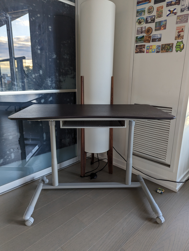 Adjustable desk on wheels with drawer