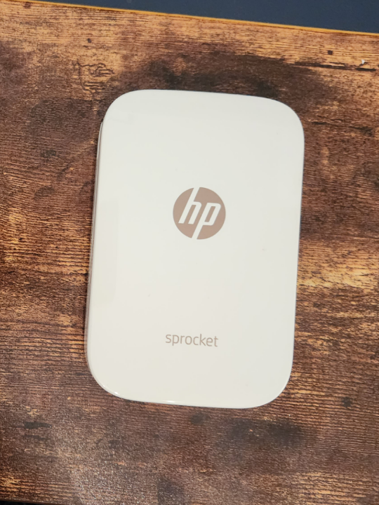 White HP Sprocket Portable Photo printer with paper and case