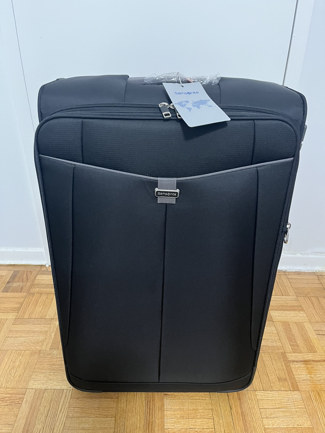 Large Black Samsonite suitcase with tags