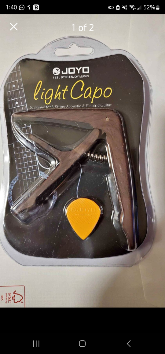 guitar capo with a pick, in Millwoods