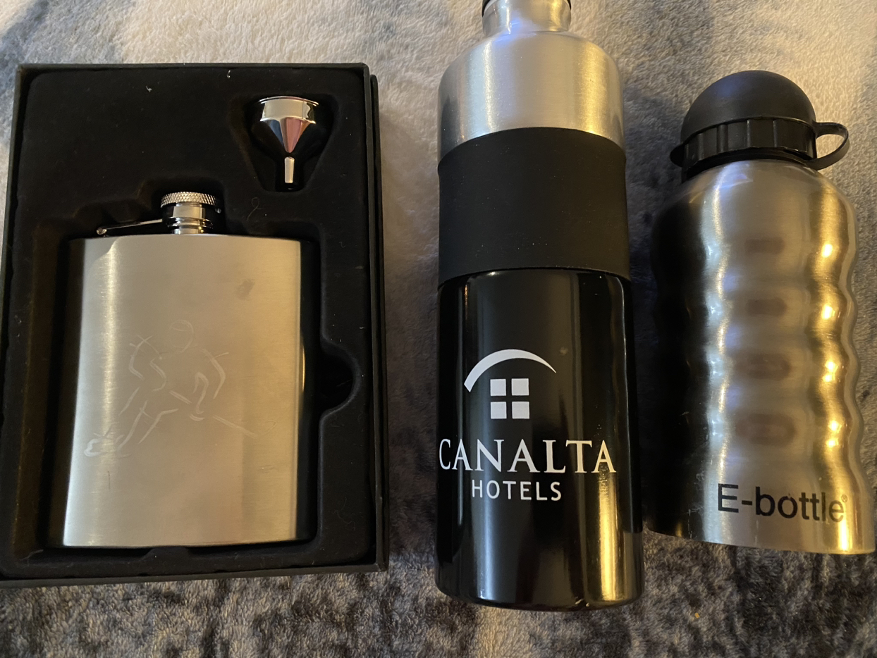 Set of stainless steel alcoholic drinks and bottles.