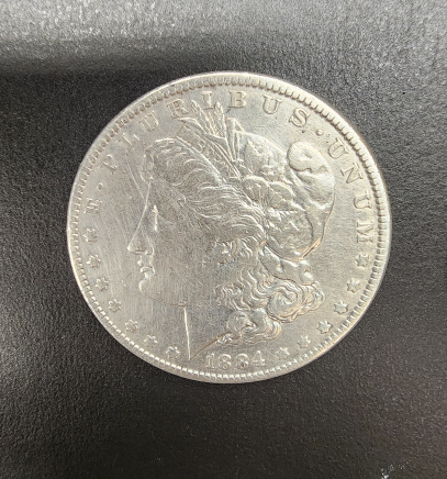 1884 Morgan dollar and 1867-1967 Canadian dollar coins