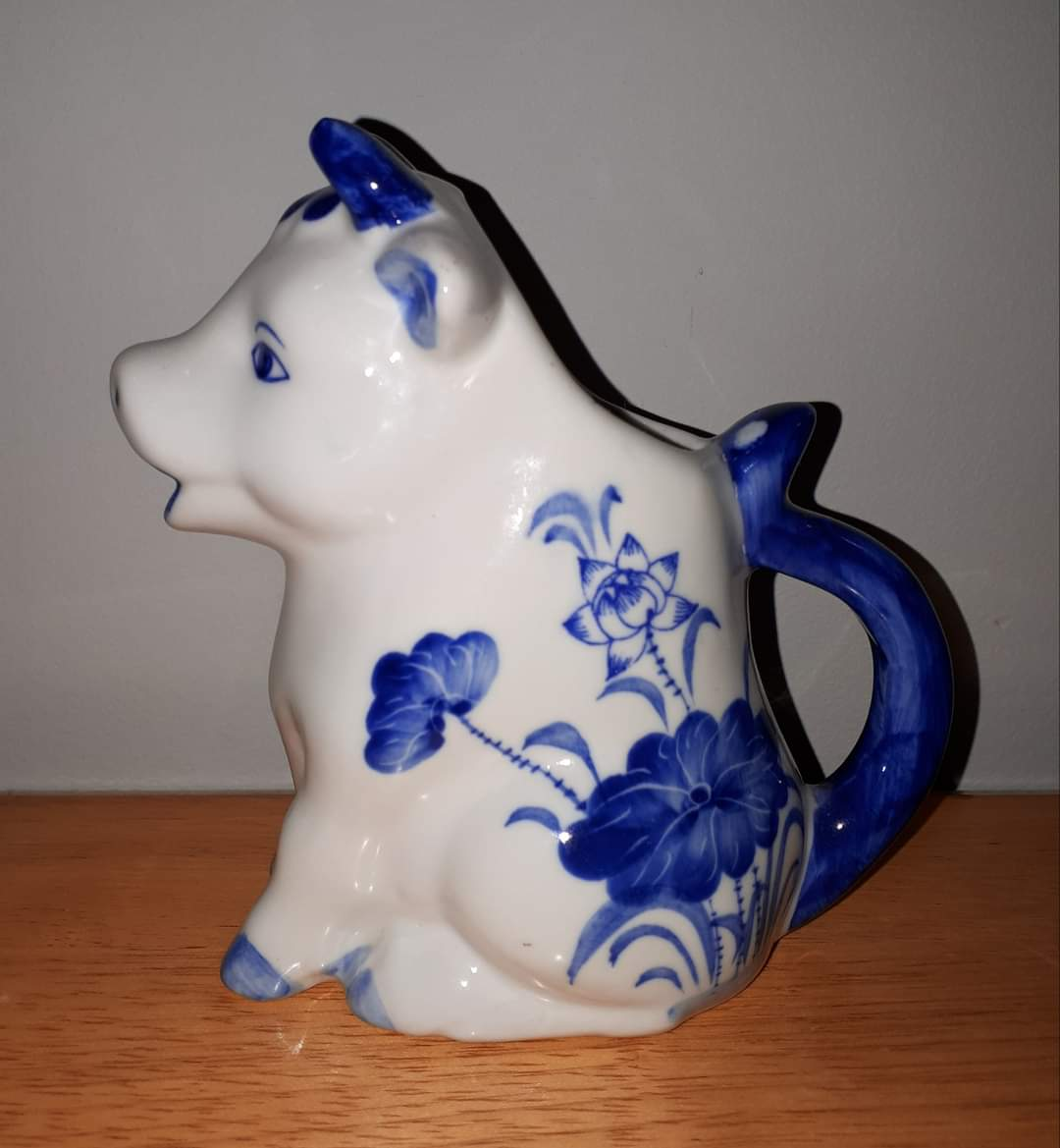 Ceramic Cow Creamer with Blue Design.
