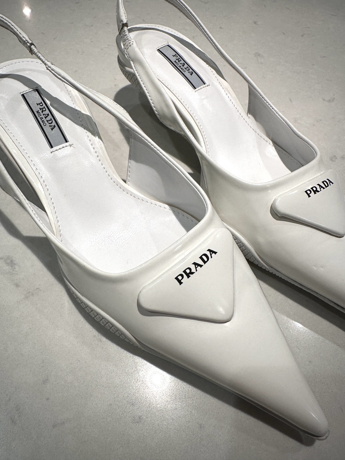 White Prada sling back kitten heels