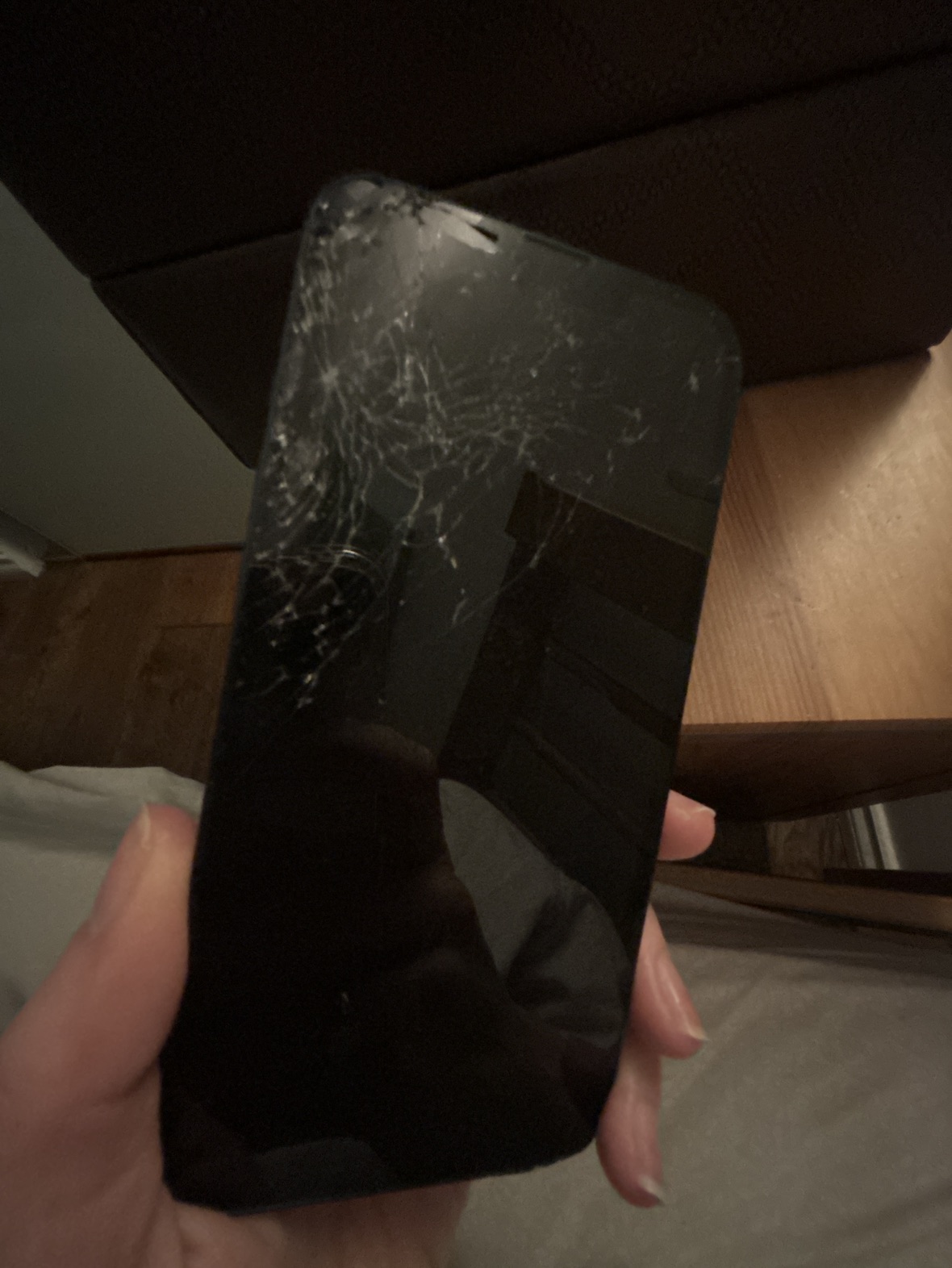 iPhone 13 with shattered screen