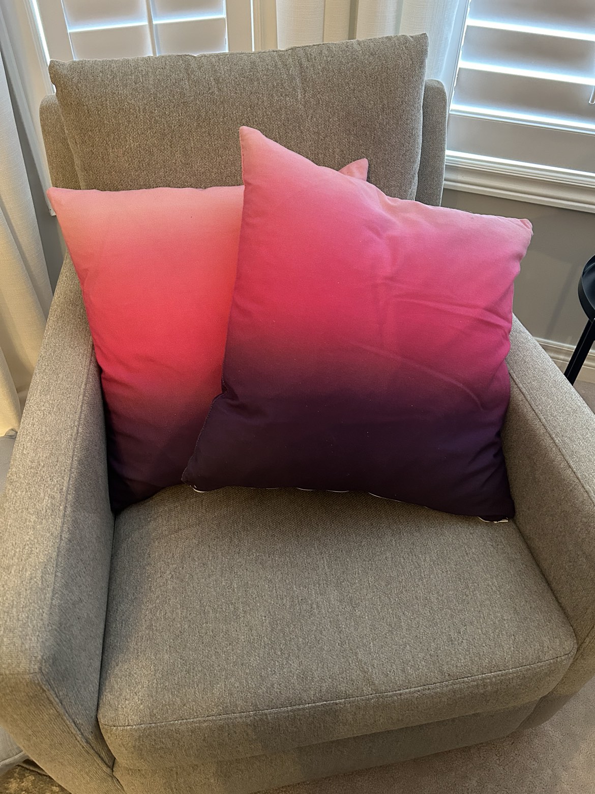 2 pink and purple decorative pillows