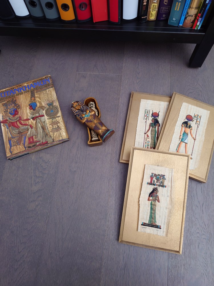Mini sarcophagus, book, and papyrus wall decorations