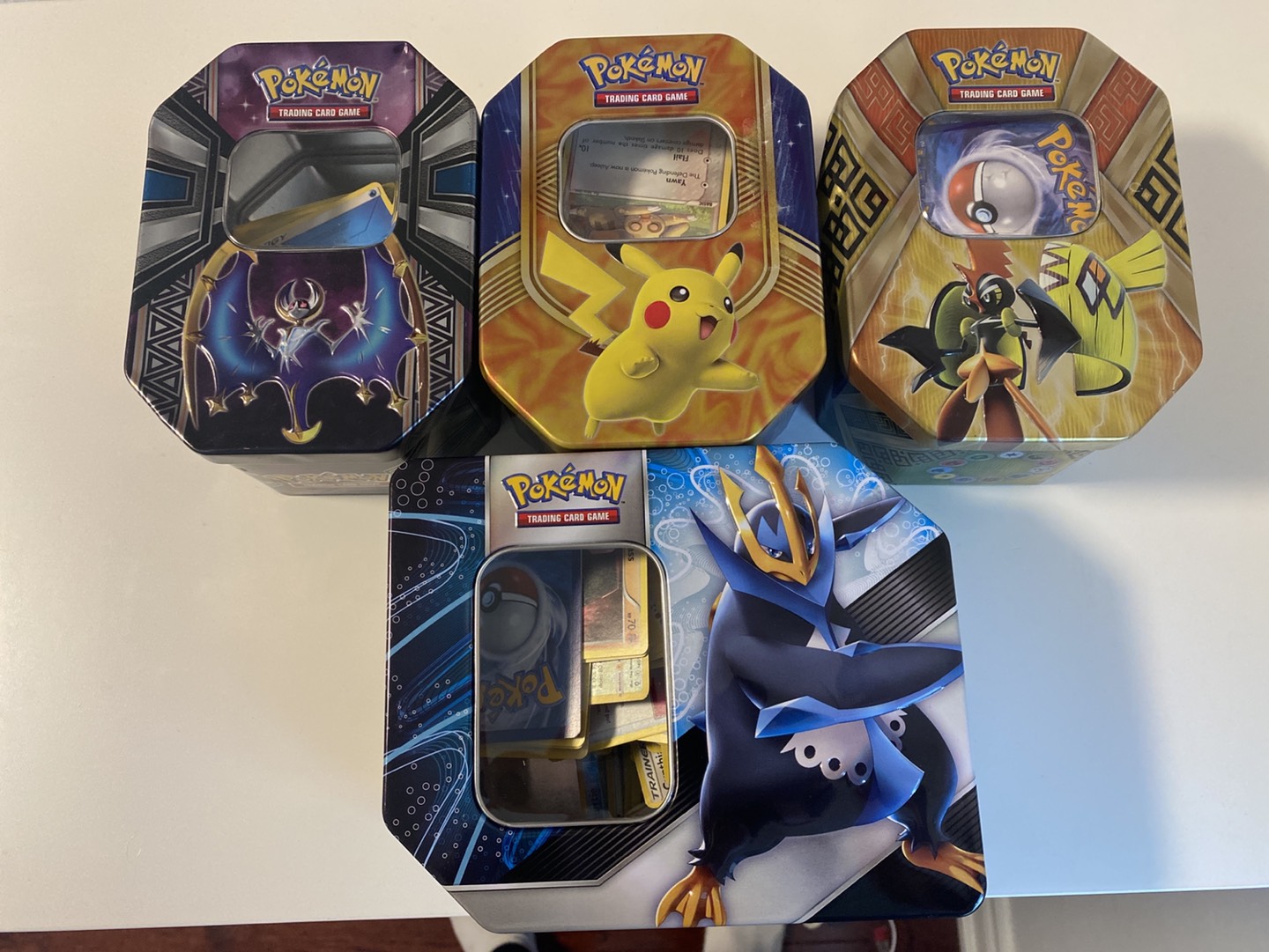 assorted pokémon tins with cards thumbnail
