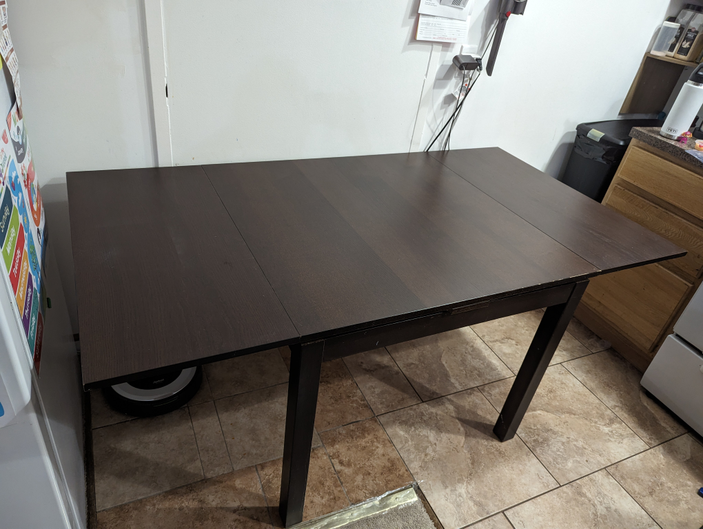 IKEA dark wood extendable dining table - photo 2