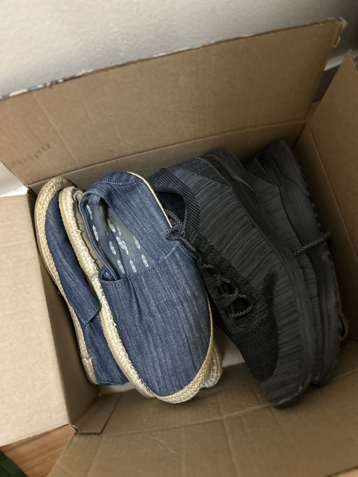 Box with bunch of male shoes