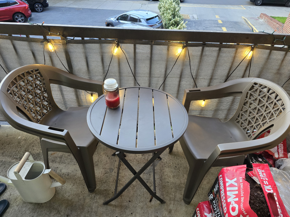 outdoor table and four plastic chairs
