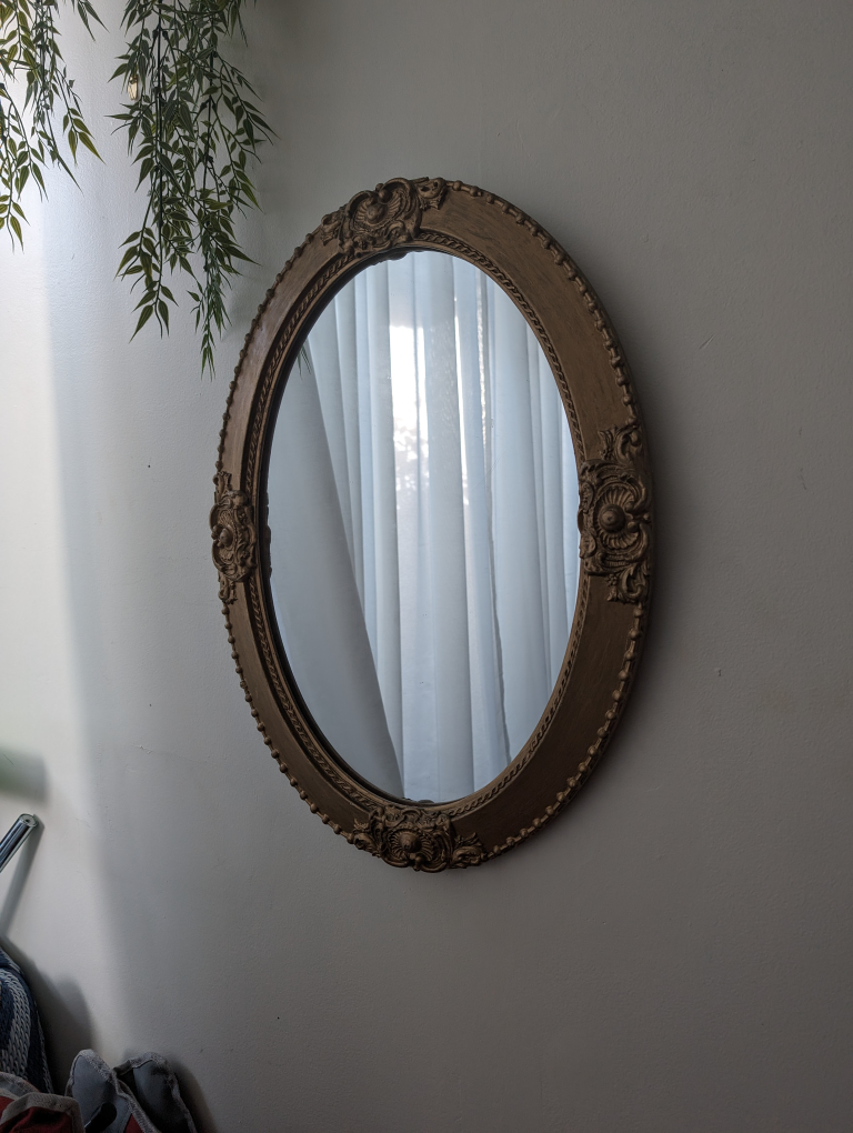 Ornate oval mirror