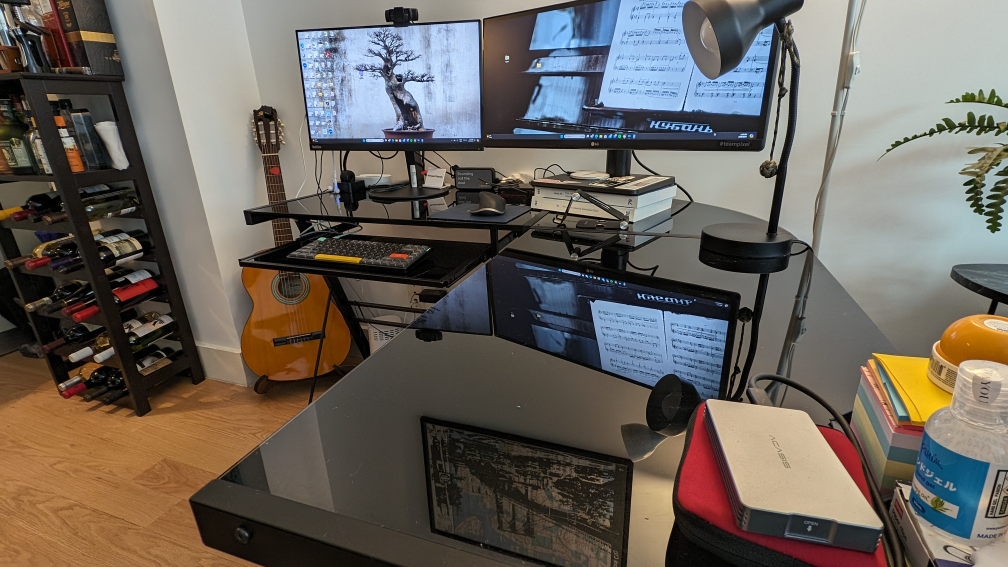 L-shaped black tempered glass desk