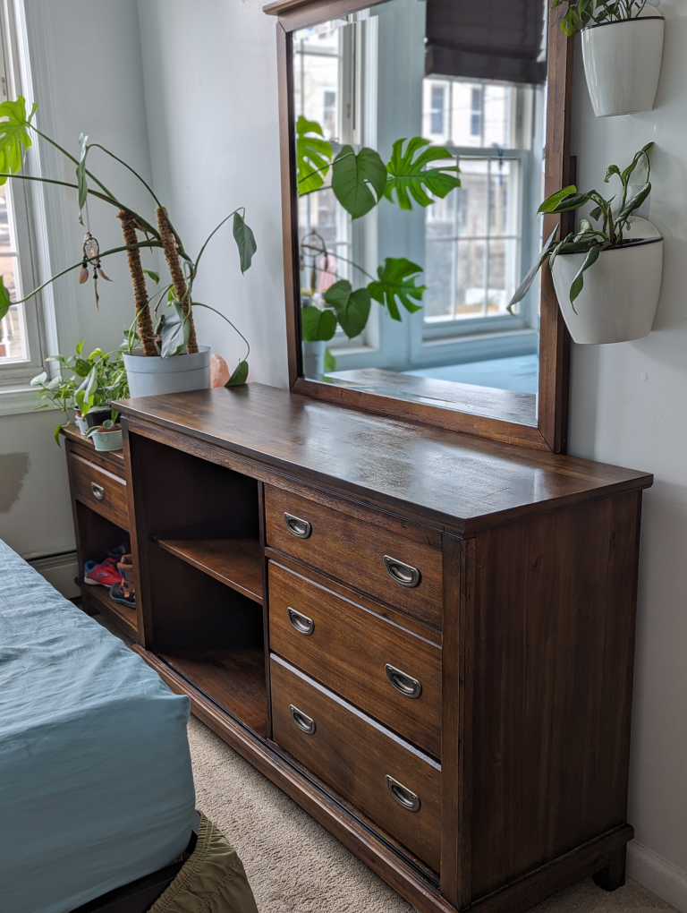 Dark wood dresser with detachable mirror.