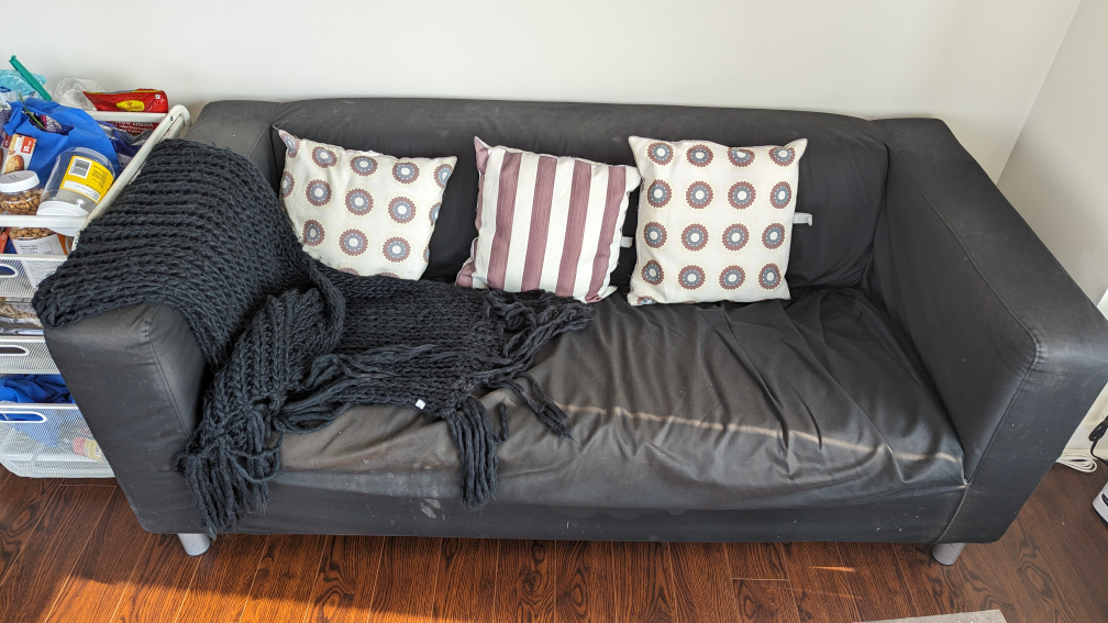 Couch with pillows and knitted blanket thumbnail